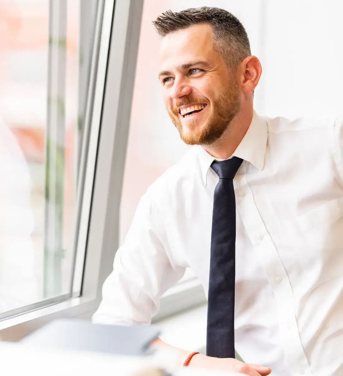 Consultant smiling by the office window