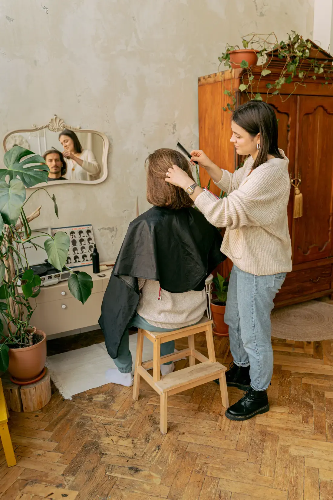 Hairdresser combing a client in her salon